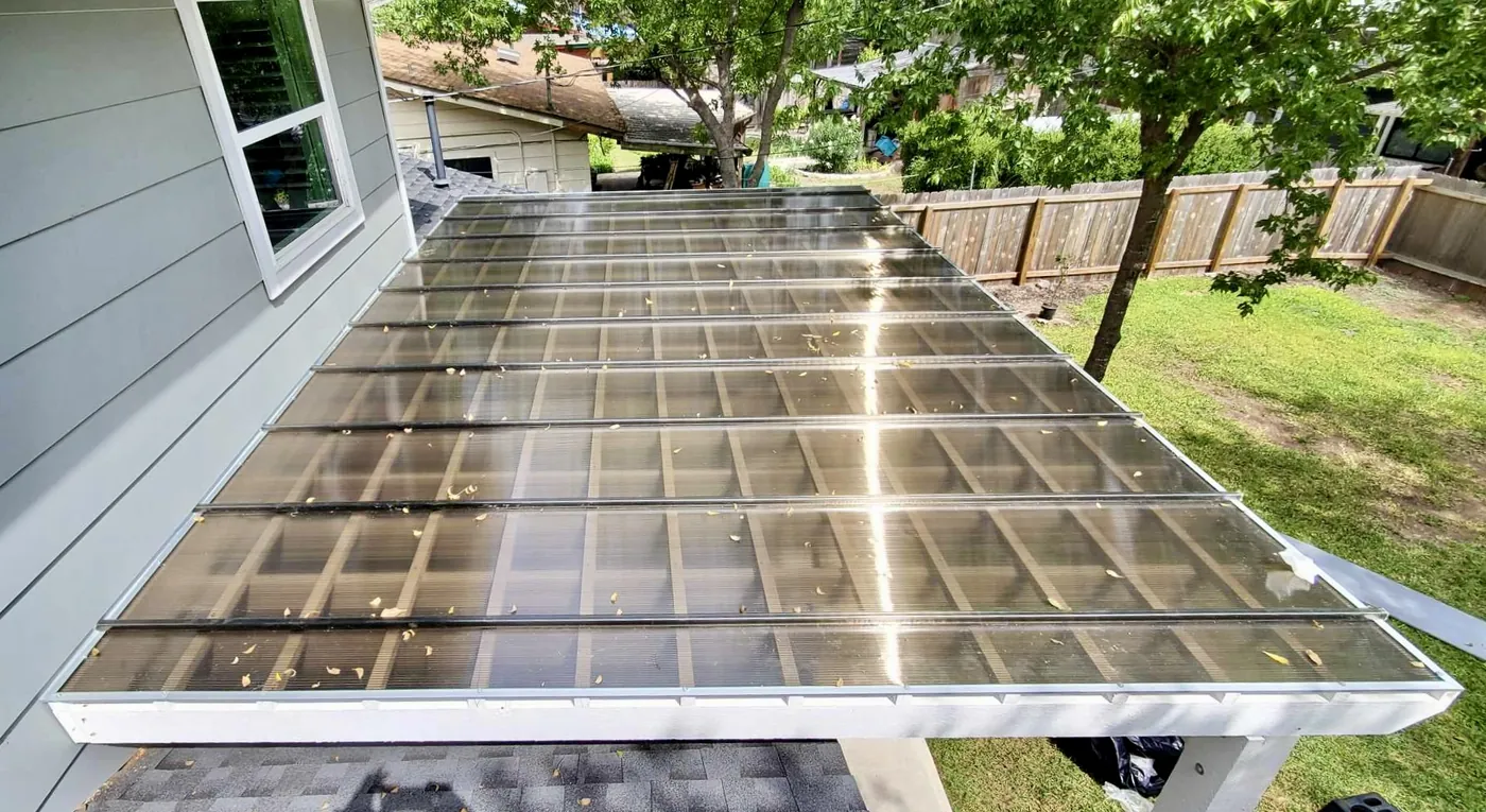Bronze Hercules polycarbonate roof installed over an existing pergola, shown from above with the drainage slope visible