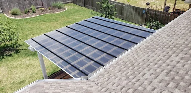 Attached traditional pergola with a bronze polycarbonate roof that filters light and blocks rain