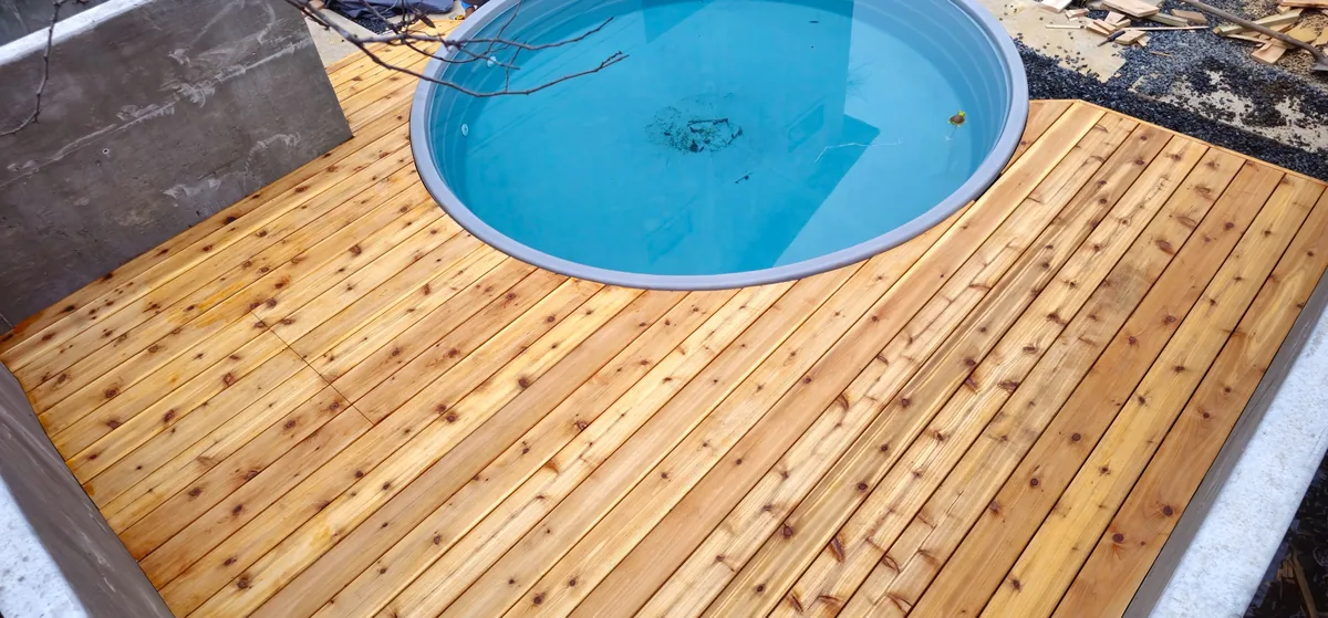 Overhead view of a custom cedar deck built around a stock tank cowboy pool
