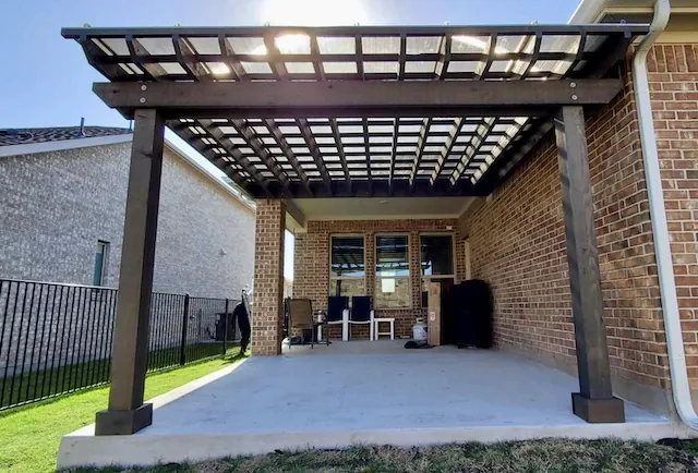 Freestanding cedar pergola with a polycarbonate roof and dark brown stain