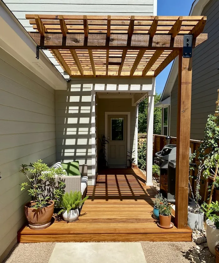 Garapa hardwood deck with attached cedar pergola, custom stained to match both woods