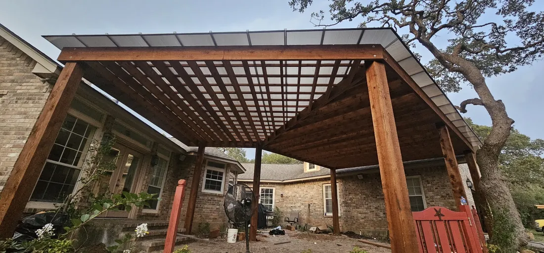 Custom-shape cedar pergola with a polycarbonate roof