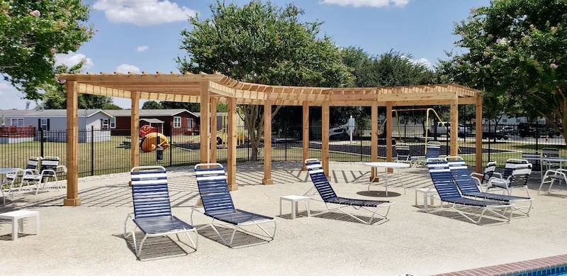 Large curved cedar pergola at a community pool area